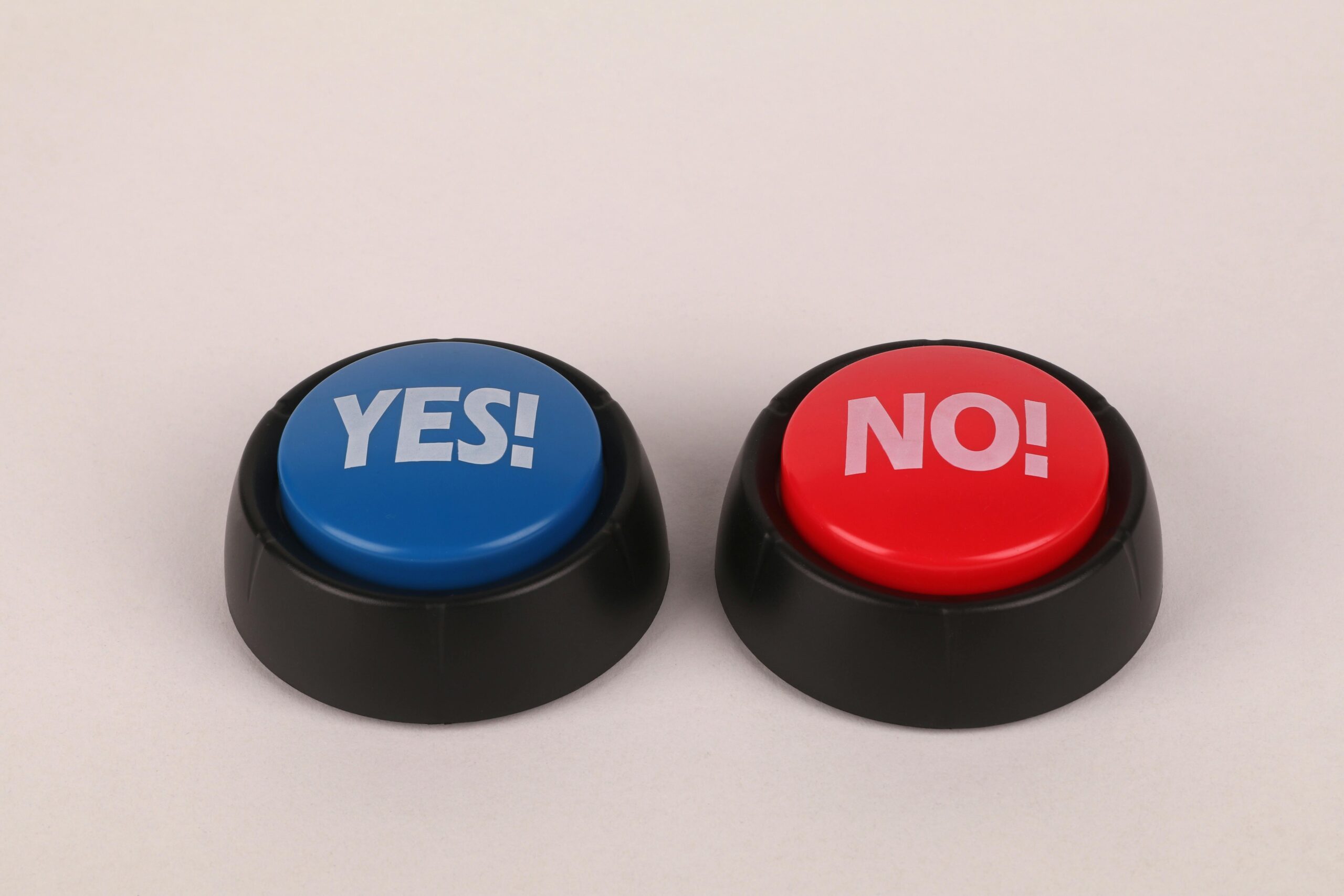 Image of vibrant blue and red push buttons labeled Yes and No against a plain background.